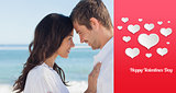 Composite image of attractive couple embracing on the beach