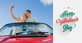 Composite image of cheerful couple standing in red cabriolet taking picture