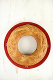 Homemade wreath cake on red plate