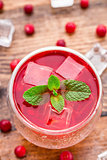 Cranberry cocktail with mint garnish.