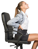 Businesswoman with lower back pain from sitting on office chair