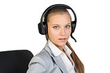 Businesswoman in headset sitting on chair