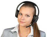 Businesswoman in headset, looking at camera