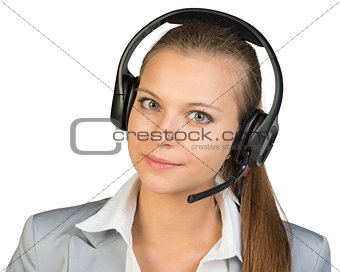 Businesswoman in headset, looking at camera