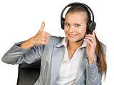 Businesswoman in headset showing thumb up