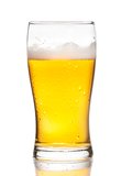 glass of fresh beer with drops on white background