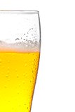 half glass of fresh beer with drops on white background