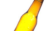 detail of tilted bottle of fresh beer with drops, with space for text