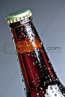 one bottle of fresh beer with drops, isolated