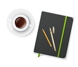 Notebook with pen and cup of coffee