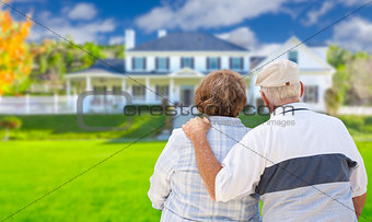 Happy Senior Couple Looking at Front of House