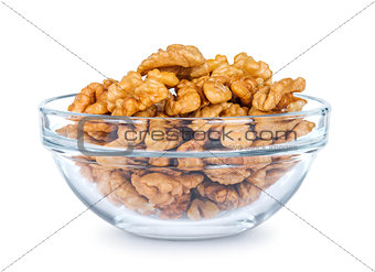 a lot of walnuts in a glass bowl on a white background