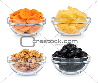 collection of dried fruit in a glass bowl on a white background