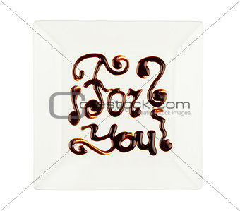 The inscription the melted chocolate isolated on white