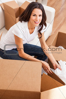 Single Woman Unpacking Packing Boxes Moving House