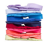 stack of colored shirt on a white background