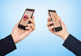 Phone cell concept. Man's hand holding phone with speaking woman