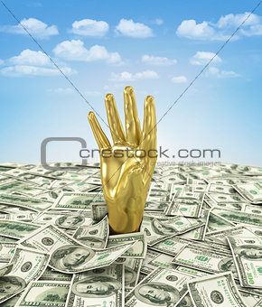 Gold hand makes its way through a bunch of dollars.