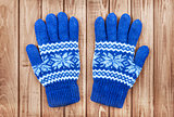 knitted mittens on a wooden background