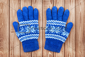 knitted mittens on a wooden background