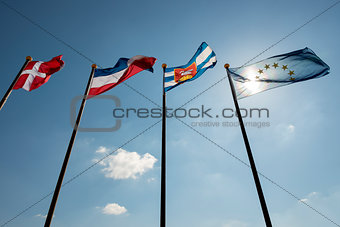 Blue sky with four flags