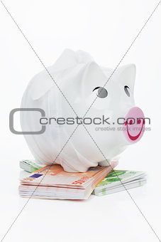 Financial crisis. Sick piggy bank on euro banknotes.