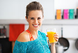 Portrait of smiling fitness young woman with glass of pumpkin sm