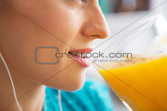 Close-up on fitness young woman drinking pumpkin smoothie