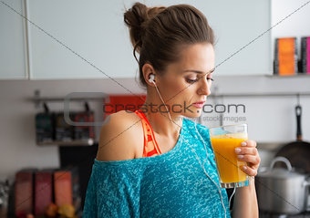 Portrait of fitness young woman drinking pumpkin smoothie in kit