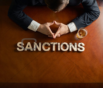 Word Sanctions and devastated man composition