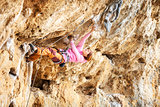 Silhouette of a young female rock climber on a cliff. Kalymnos Island