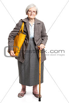 Elegant senior woman with walking stick standing over white