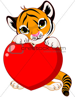 Cute tiger cub holding heart