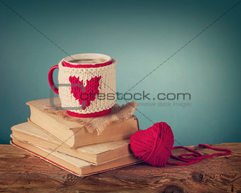Cup of coffee standing on an old book 