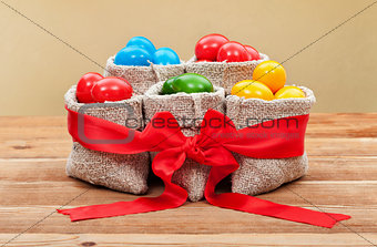 Colorful easter eggs in burlap bags - festive arrangement