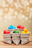 Colorful easter eggs in burlap bags