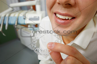 Smiling man holding silicone mouth guard