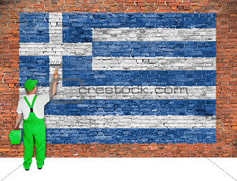 House painter paints flag of Greece on brick wall