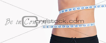 Fit belly surrounded by measuring tape