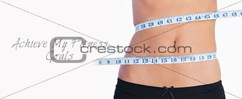 Fit belly surrounded by measuring tape