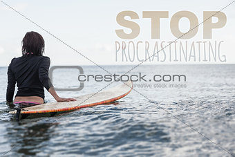 Composite image of rear view of a woman with surfboard in the water