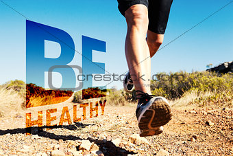 Composite image of athletic man jogging on country trail