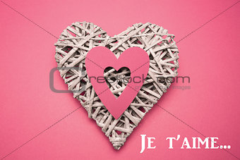 Composite image of wicker heart ornament with paper cut out