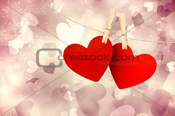 Composite image of hearts hanging on line