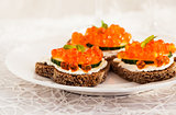 Heart shaped toasts  with red caviar and white wine