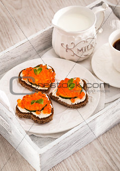 Romantic breakfast-toasts  with red caviar and coffee