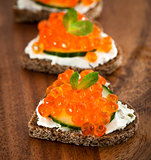 Heart shaped toasts with red caviar