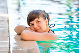 portrait of a beautiful young girl in the pool