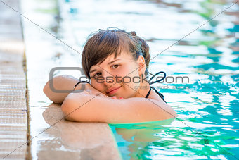 portrait of a beautiful young girl in the pool