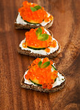 Heart shaped toasts with red caviar